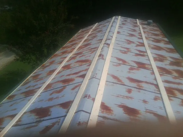 Rusted metal roof panels with new wood purlins before replacement — Storm Damage Roof Repair in Nolensville by Roofing Brothers