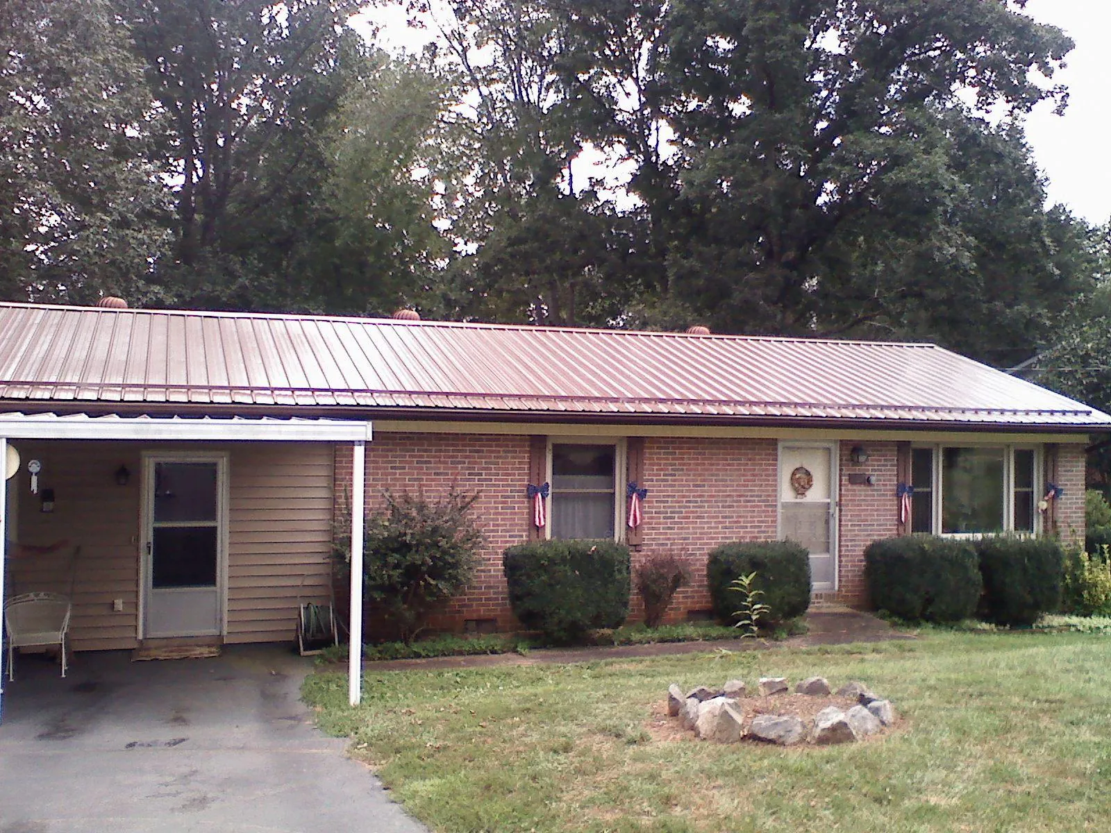Bronze metal roof and carport on a brick ranch home — Roof Repair work by our crew in Nolensville